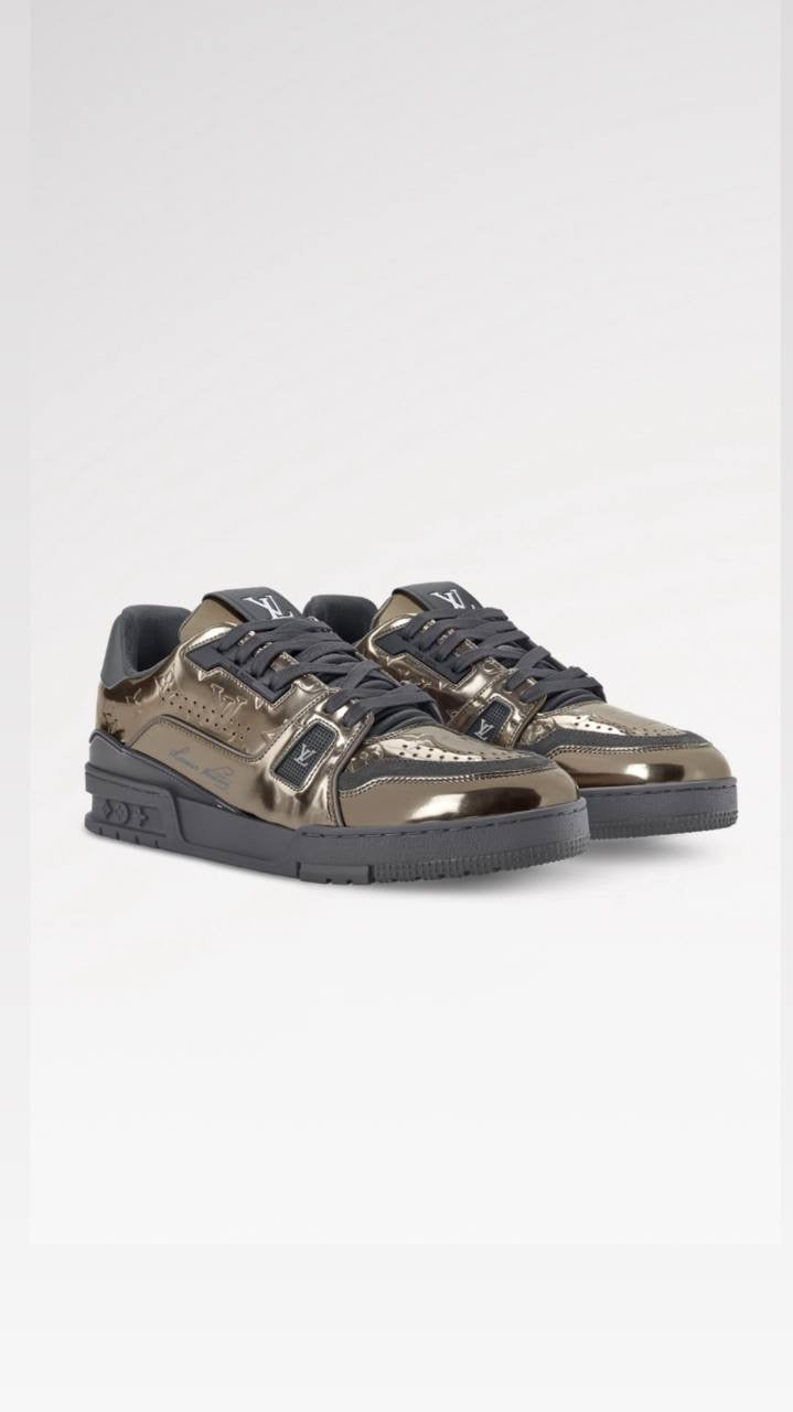 Louis Vuitton LV Trainer sneaker is crafted from Monogram-embossed synthetic leather with a metallic mirror finish.