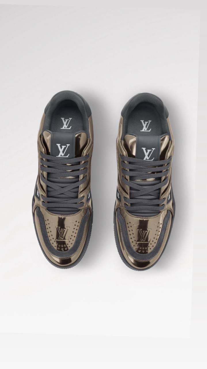 Louis Vuitton LV Trainer sneaker is crafted from Monogram-embossed synthetic leather with a metallic mirror finish.