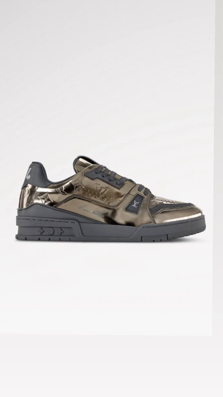Louis Vuitton LV Trainer sneaker is crafted from Monogram-embossed synthetic leather with a metallic mirror finish.
